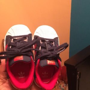 Red, white, and blue Adidas